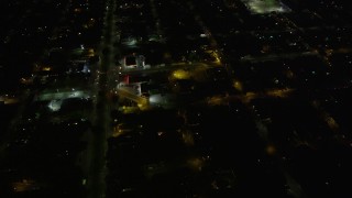 AX62_047 - 5K aerial stock footage of urban neighborhoods around St Roch Park at night, New Orleans, Louisiana