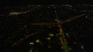 AX62_048 - 5K aerial stock footage approach freeway interchange in at night, New Orleans, Louisiana