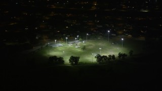 AX63_003 - 5K aerial stock footage of a baseball field in Gentilly at night, New Orleans, Louisiana