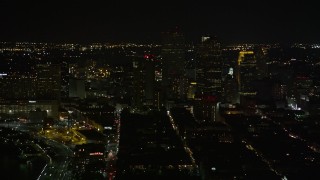 AX63_004E - 5K aerial stock footage of Downtown New Orleans at night, seen from the French Quarter, Louisiana