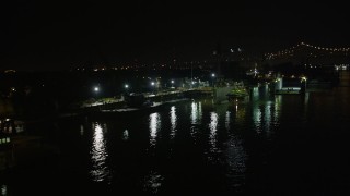 AX63_010 - 5K aerial stock footage flyby Algiers Ferry Terminal and piers on the Mississippi River at night in Algiers, New Orleans, Louisiana