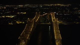 AX63_015 - 5K aerial stock footage flyby the Crescent City Connection Bridge at night, New Orleans, Louisiana