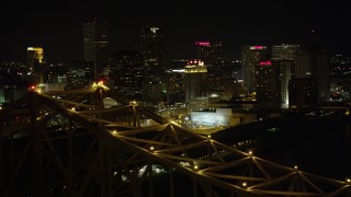 AX63_016 - 5K aerial stock footage orbit top of Crescent City Connection Bridge at night to reveal Downtown New Orleans, Louisiana