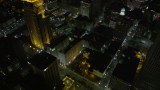 AX63_031E - 5K aerial stock footage of bird's eye of Downtown New Orleans skyscrapers and streets at night, Louisiana