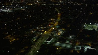 AX63_034 - 5K aerial stock footage fly over shops and Earhart Boulevard at night, Carrollton, New Orleans, Louisiana