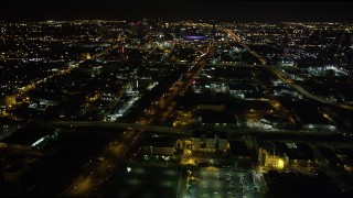 AX63_038 - 5K aerial stock footage pan across I-10 in Mid-City to reveal and approach Downtown New Orleans at night, Louisiana