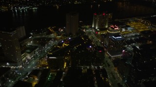 AX63_041E - 5K aerial stock footage of following Poydras Street through Downtown New Orleans at night, Louisiana