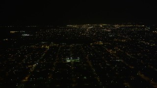 AX63_046 - 5K aerial stock footage of neighborhoods in New Orleans East at night, Louisiana