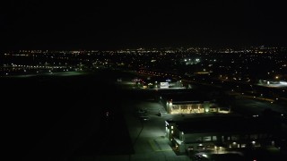 AX63_049 - 5K aerial stock footage flyby neighborhoods in New Orleans East to reveal Lakefront Airport at night, Louisiana