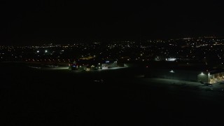 AX63_050 - 5K aerial stock footage of civilian plane taxiing at New Orleans Lakefront Airport at night, Louisiana