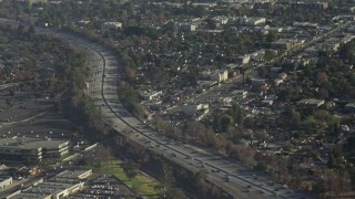 AX64_0006E - 5K aerial stock footage of Highway 170 with light traffic beside a shopping center in North Hollywood, California