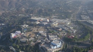 AX64_0012 - 5K aerial stock footage of approach and tilt to theme park in Universal City in California