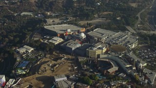 AX64_0012E - 5K aerial stock footage of approach and tilt to theme park in Universal City in California