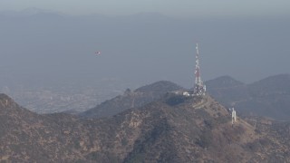 AX64_0014 - 5K aerial stock footage of emergency helicopter flying near Hollywood Sign, Los Angeles, California