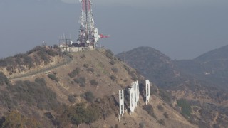 AX64_0017 - 5K aerial stock footage of emergency helicopter landing above the Hollywood Sign, Los Angeles, California