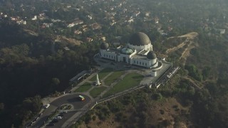 AX64_0019E - 5K aerial stock footage approach the Griffith Observatory in haze, Los Angeles, California