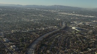 AX64_0027E - 5K aerial stock footage of the Highway 170 freeway between suburban neighborhoods in North Hollywood, California