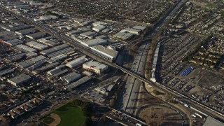 AX64_0030E - 5K aerial stock footage of warehouse buildings beside Highway 170 freeway in North Hollywood, California