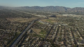 AX64_0032 - 5K aerial stock footage fly over suburban homes to approach Highway 170 / I-5 freeway split in Sun Valley, California