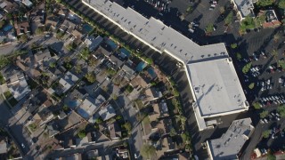 AX64_0035 - 5K aerial stock footage of suburban homes and Canyon Plaza Shopping Center in Sun Valley, California