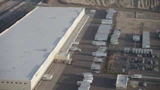 AX64_0045 - 5K aerial stock footage of a Fed-Ex warehouse in Pacoima, California