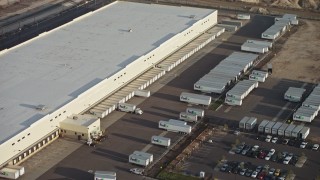 AX64_0045E - 5K aerial stock footage of a Fed-Ex warehouse in Pacoima, California