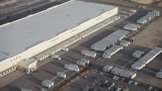AX64_0046 - 5K aerial stock footage of trucks and trailers at a Fed-Ex warehouse in Pacoima, California