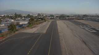 AX64_0047 - 5K aerial stock footage of lifting off from the runway at Whiteman Airport, Pacoima, California