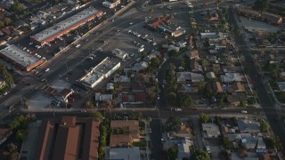 AX64_0055E - 5K aerial stock footage fly over homes, apartment building, and reveal a strip mall in Sun Valley, California