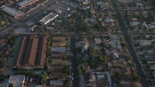 AX64_0056 - 5K aerial stock footage fly over homes, apartment building, and reveal a strip mall in Sun Valley, California