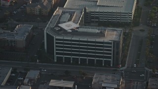 AX64_0060E - 5K aerial stock footage approach office building with helipad on the rooftop in Burbank, California