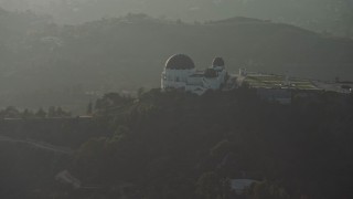 AX64_0072E - 5K aerial stock footage flyby the Griffith Observatory in haze, Los Angeles, California