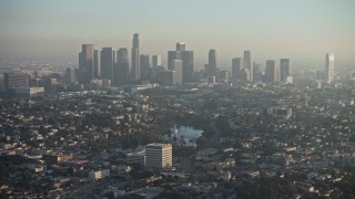 AX64_0076E - 5K aerial stock footage of Downtown Los Angeles and city sprawl in haze, California