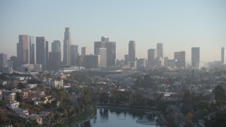 AX64_0081 - 5K aerial stock footage fly over Echo Lake to approach the Downtown Los Angeles skyline, California