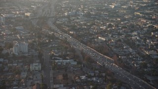 AX64_0109 - 5K aerial stock footage of Highway 101 by East Hollywood homes, Los Angeles, California, sunset