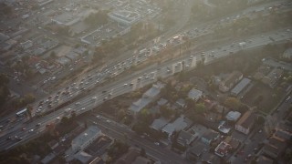 AX64_0110E - 5K aerial stock footage of heavy traffic on Highway 101 in East Hollywood, Los Angeles California sunset