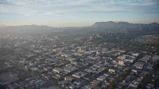 AX64_0112E - 5K aerial stock footage fly over neighborhoods in East Hollywood and approach Hollywood Sign, Los Angeles, California, Sunset
