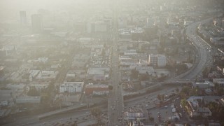 AX64_0115 - 5K aerial stock footage follow Hollywood Boulevard in Los Angeles, California, sunset