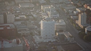 AX64_0116 - 5K aerial stock footage of Capitol Records Building in Hollywood, California, sunset