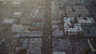 AX64_0117E - 5K aerial stock footage of cars on Hollywood Boulevard through Hollywood, California, Sunset