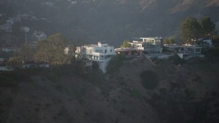 AX64_0122 - 5K aerial stock footage flyby mansions in Hollywood Hills, California sunset