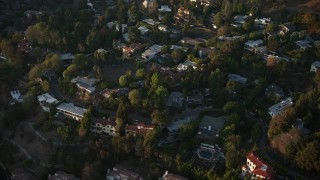 AX64_0124 - 5K stock footage aerial video fly over hillside homes in Hollywood Hills, California, sunset