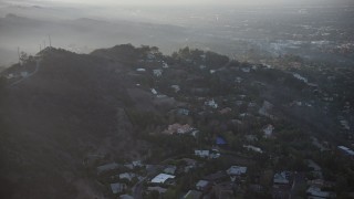 AX64_0125 - 5K aerial stock footage flyby luxury homes in the Hollywood Hills, California, sunset