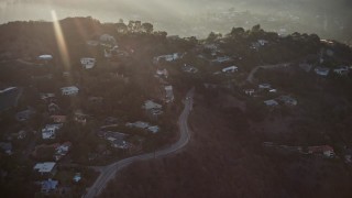 AX64_0125E - 5K aerial stock footage flyby luxury homes in the Hollywood Hills, California, sunset