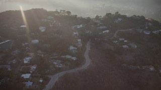AX64_0126 - 5K aerial stock footage of passing homes on a hillside in Hollywood Hills, California, sunset