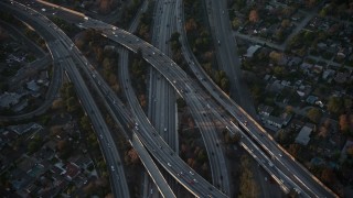 AX64_0127E - 5K aerial stock footage tilt to bird's eye view of Highway 170 and 134 freeway interchange in Toluca Lake, California, sunset