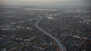 AX64_0129E - 5K aerial stock footage of Highway 170 and North Hollywood suburbs, California, sunset
