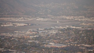 AX64_0131 - 5K aerial stock footage of Bob Hope International Airport in Burbank, California, sunset