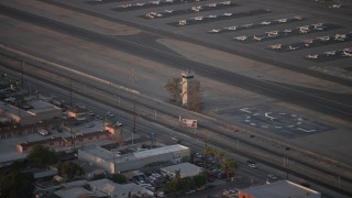 AX64_0139 - 5K aerial stock footage of the control Tower at Whiteman Airport in Pacoima, California, sunset