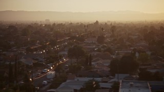 AX64_0141 - 5K aerial stock footage of urban neighborhoods in Pacoima, California, sunset